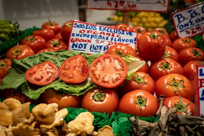 Fresh tomatoes and vegetables at a produce market
